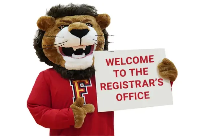 Flagler College lion mascot holding a sign that reads Welcome to the Registrar's Office.
