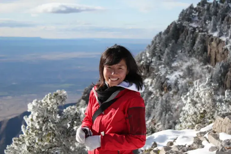 Landscape photo of Dr. Maggie Cao on mountainside