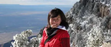 Landscape photo of Dr. Maggie Cao on mountainside