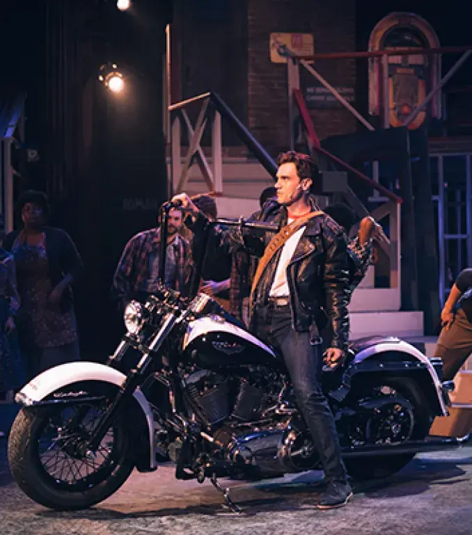 Student on motorcycle in All Shook Up 