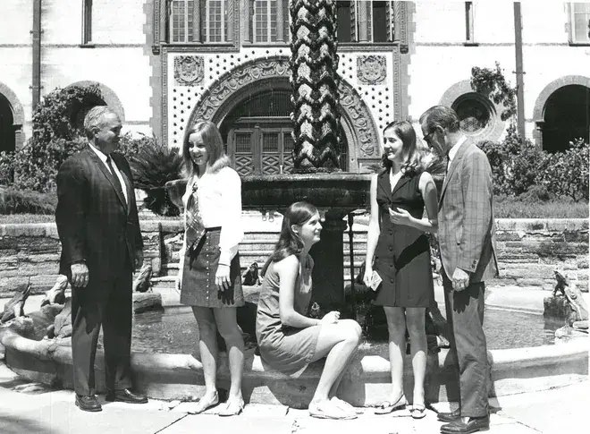 Early students and professors in the courtyard