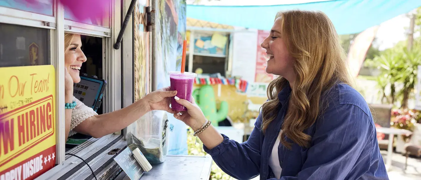 Student grabbing a smoothie from an alumni owned business