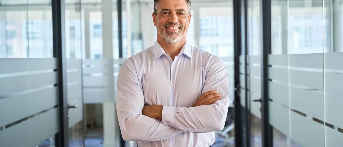 Employer crossing their arms in a board room