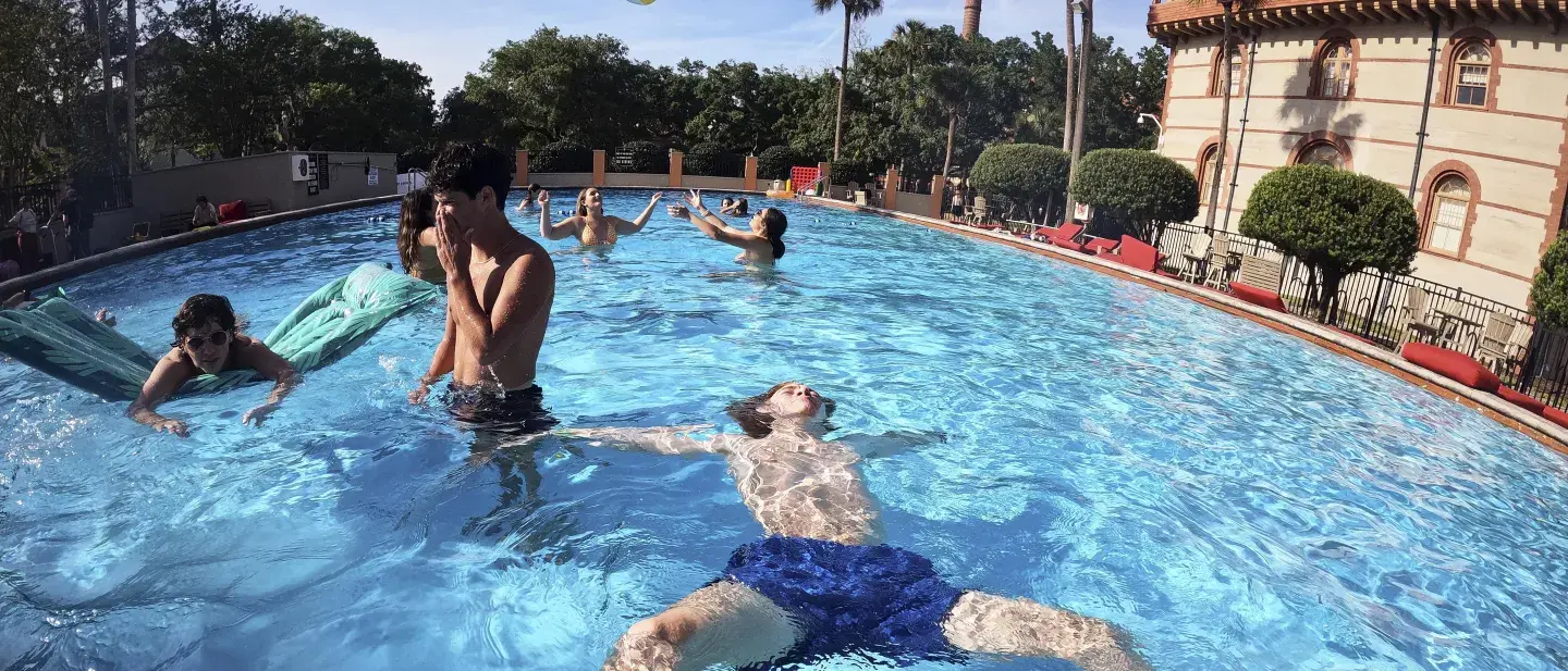 Flagler College students relax and play in one of two pools.