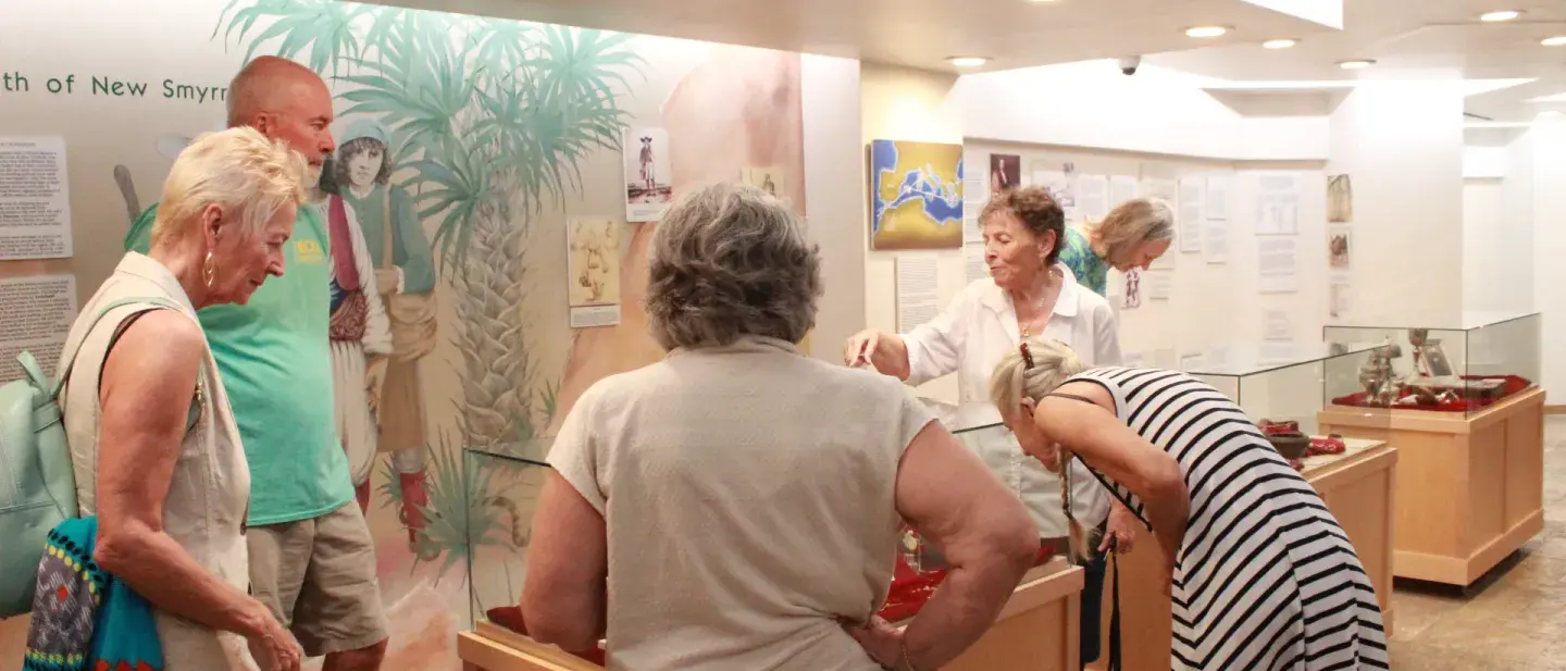 A lifelong learning instructor leads a class at a museum.