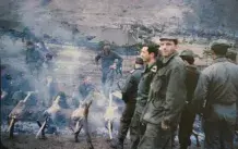 John Iakovides with a Greek regiment roasting lamb for Easter