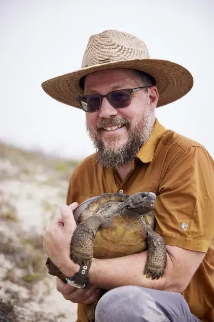 Ben Atkinson holding a tortoise