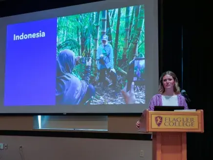 COM Week 2024 Abigail Kreinheder Presenting at Podium