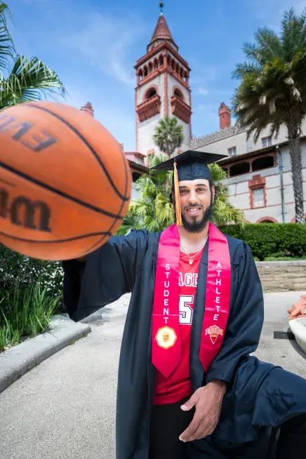 Tyler Collier holding a basketball toward the camera