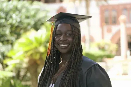 Close-up of Amuk in cap & gown