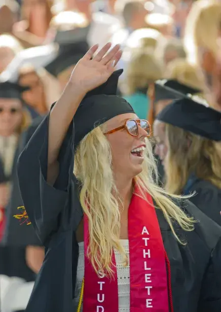 Caroline waving to crowd at Commencement