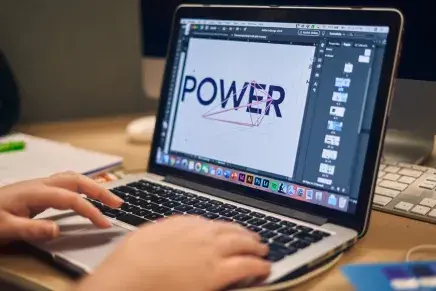 Graphic design student working on computer
