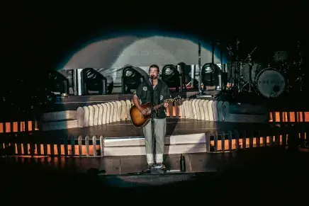 Noah Kahan on stage singing