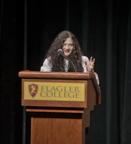 Zevin at podium during speech