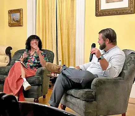 Lima and Hooks sitting in chairs in Markland's yellow room for book talk Q&A