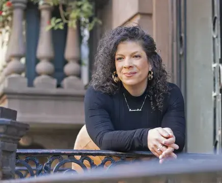Cassandra Schaffa leaning on railing pose