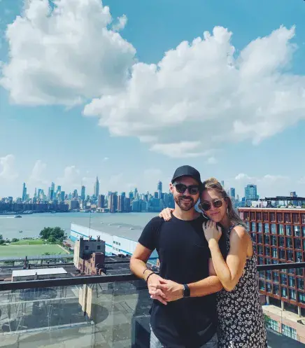 Luis & (now) wife posing with NYC skyline