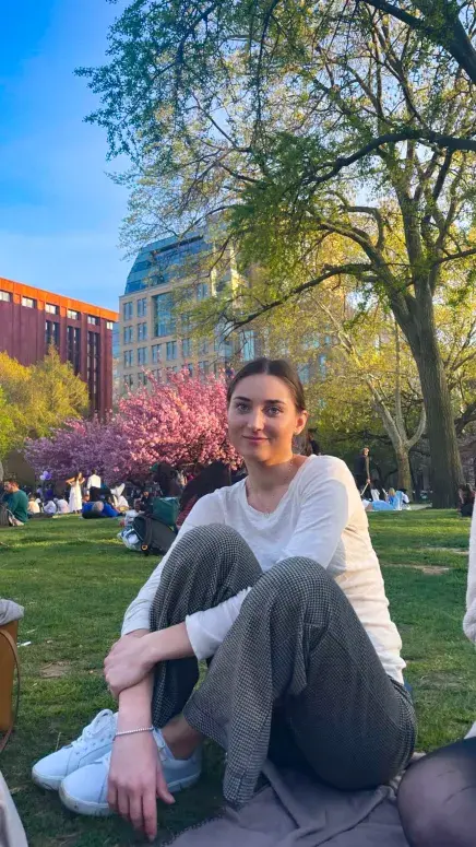 Marietta sitting in the grass at a park