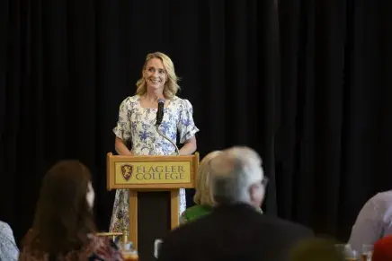 Laura Neal speaking at alumni awards luncheon 2025