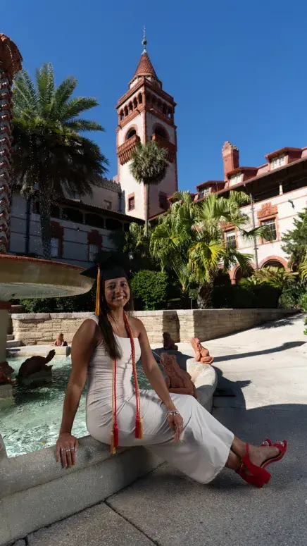 Destinee Lagunas sitting in the Ponce courtyard by the fountain