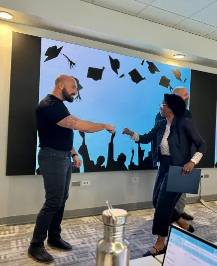 Dr. Bryant Fist Bumping a man at UF AI Workshop