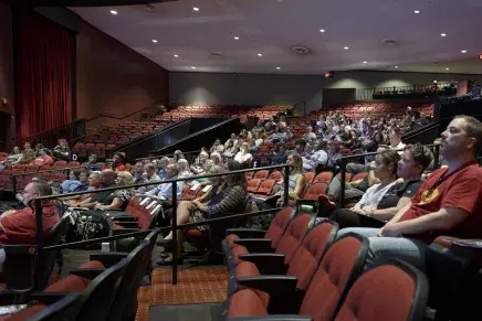 Faculty and staff sitting in the auditorium