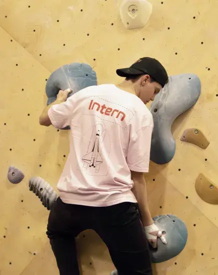 Vice president Patrick Coleman makes his way up the wall at Stone Climbing Gym