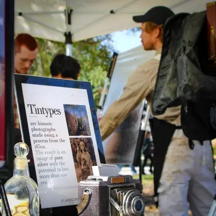 Photo of the St. Augustine Tin Type Booth and sign describing the process.