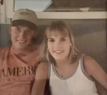 Jennifer and Jerry Goodrich in an early photo smiling at the camera for a staged photo