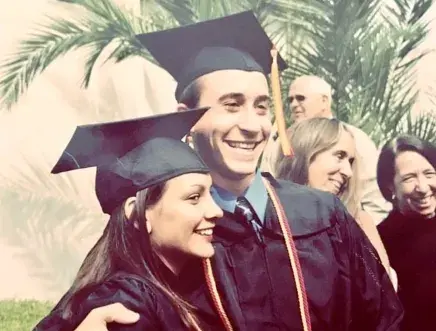 Emma and Drew Murfin at their Flagler College graduation dressed in full cap and gown