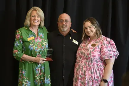 Jerry Provin Receiving Lionhearted Award - a woman on both sides of him