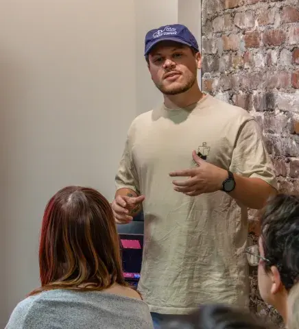 Flagler alum Mason Mushinski giving a presentation to Flagler students