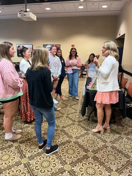 A teacher presents to students at an education week workshop
