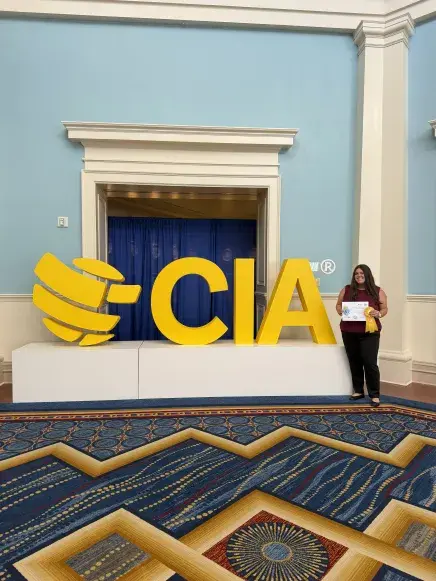 Student, Jamey Amador with CIA sign