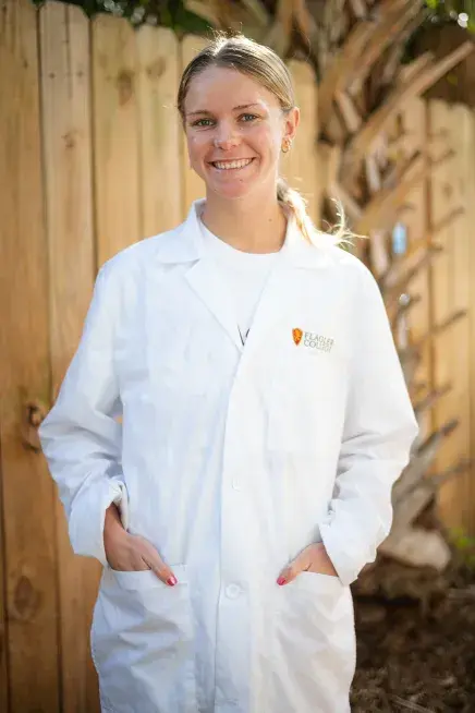Zoie Marchant poses in a white lab coat