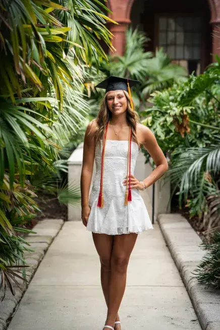 Carleigh Grimm poses in The Ponce courtyard with her graduation cap on