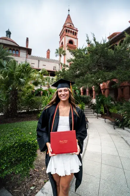 Carleigh Grimm holding her diploma