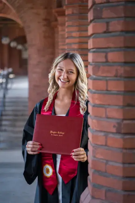 Carly Stern holding her diploma