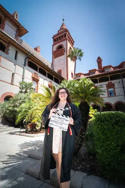 Abby Surber poses with a clap board in the Ponce courtyard