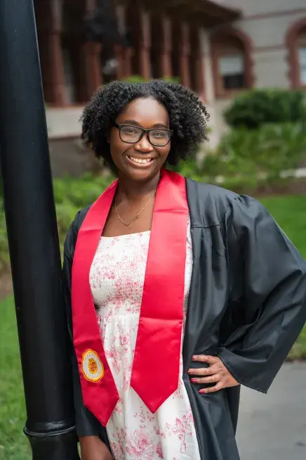 Destiny Durand posing in her graduation regalia