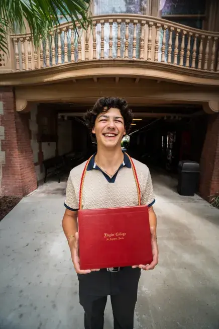 Randy Giglio holding his diploma