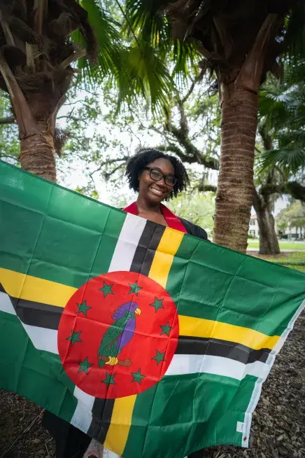Destiny Durand holding the flag of Dominica