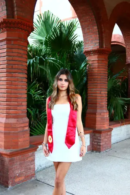 Maria Montero posing in some of her graduation regalia
