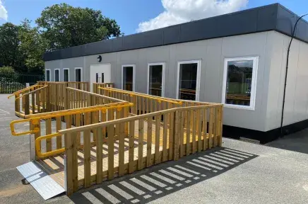Photo of Modular Science Lab - white building with wood ramp