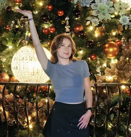 Sydney Eichhorn in front of a christmas tree