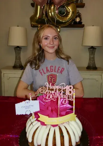 Jenna Rose Pereira-Fernandez Sits with a Flagler Tee Shirt On