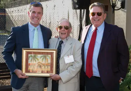 Jud Damon and President John Delaney presenting award to Lewis Pollard