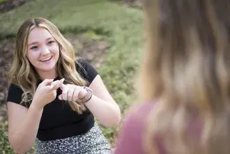A student practices sign language.