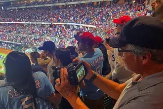 Jim Gilmore taking video at a baseball game