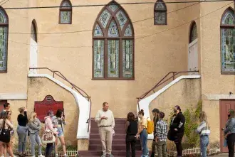 A faculty member speaks to students in front of an important Civil Rights site in St. Augustine.